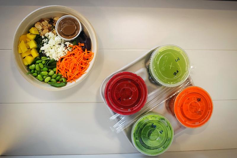 Freshii Metaboost Salad and carrying tray of juice cleanses