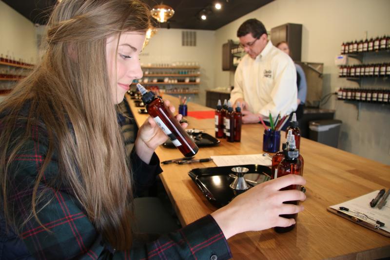 Rachel smelling Candle Fusion scents in bottles
