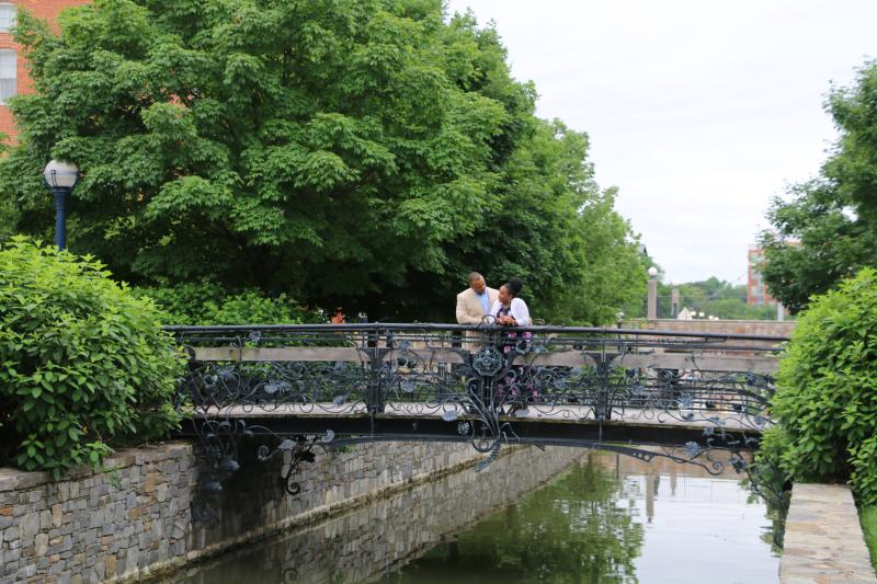 Couple standing on Carroll Creek Park Iron Bridge