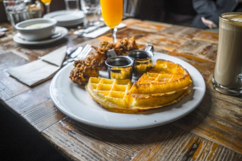 Brown Sugar Kitchen chicken and waffles with a mimosa and coffee drink