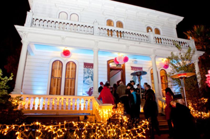 Image of Peralta House lit up during the holidays