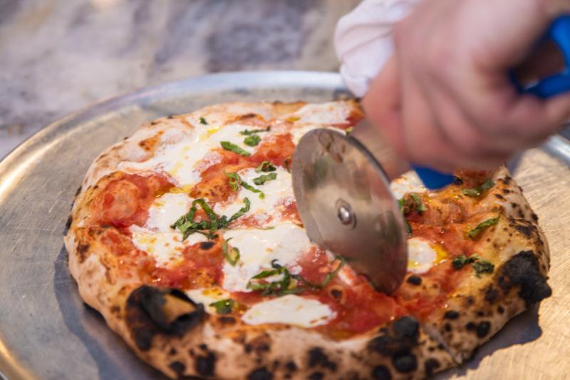 Pizza being cut
