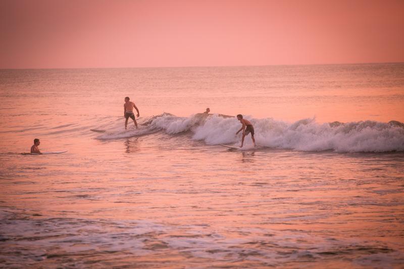 4 people out for a morning surf session at Croatan Beach