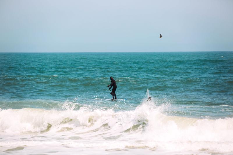 Man Paddleboarding At Sandbridge In Virginia Beach, VA