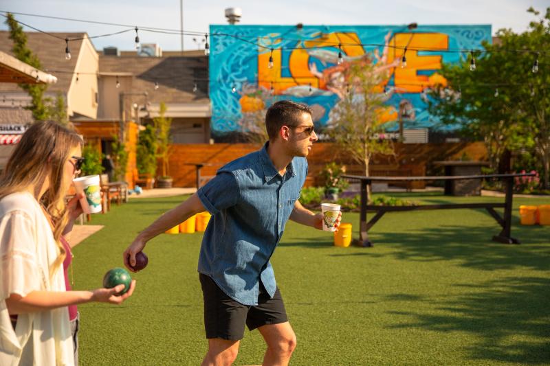 Man and woman playing bocce ball at The Shack on 8th