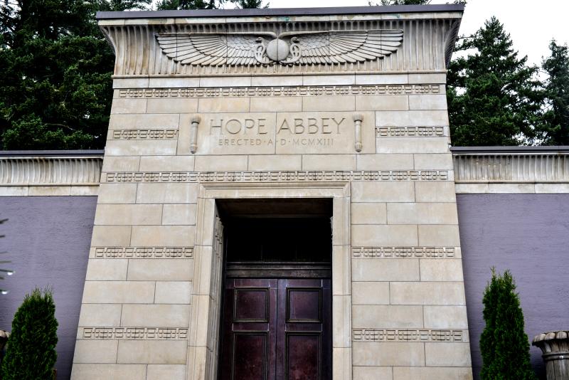 Eugene Masonic Cemetery by Melanie Griffin Mausoleum with a large wooden door, details of a large winged scarab and the words "Hope Abbey" at Eugene Masonic Cemetery.