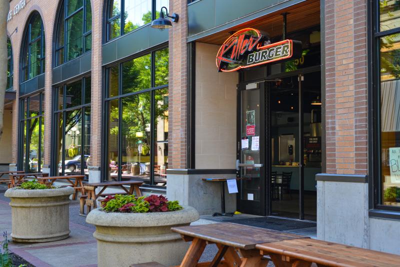 Killer Burger downtown by Melanie Griffin Large flower pots and outdoor dining tables in front of Killer Burger neon sign. Photo by Melanie Griffin