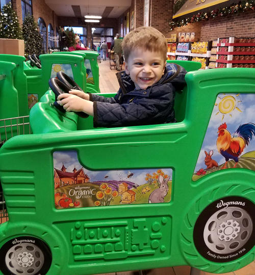 Hudson driving Wegmans green car in Canandaigua