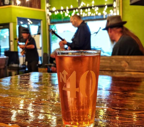 Pint of beer in front of local band playing