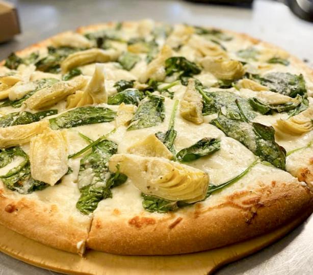 Fresh spinach, artichoke hearts and mozzarella cheese pizza