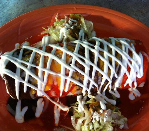 Large carne asada burrito drizzled with sour cream