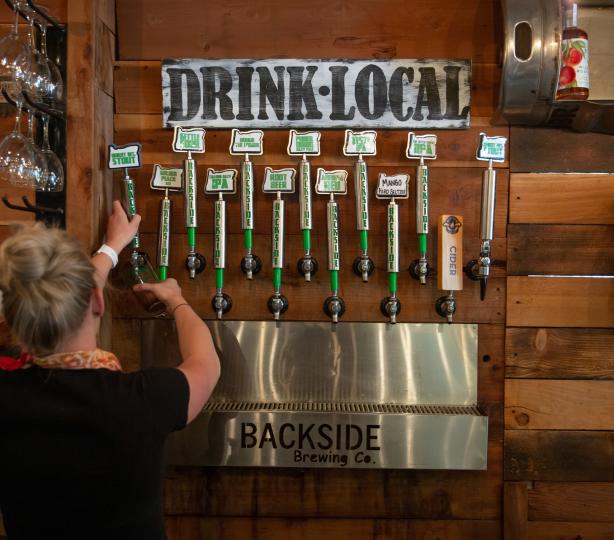 Wall of beer taps at Backside Brewing