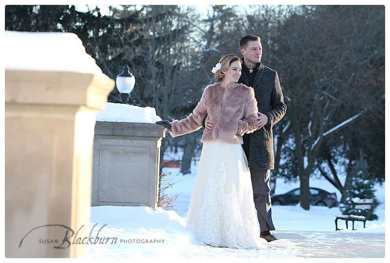 Couple outside on wedding day during the winter with fur coat