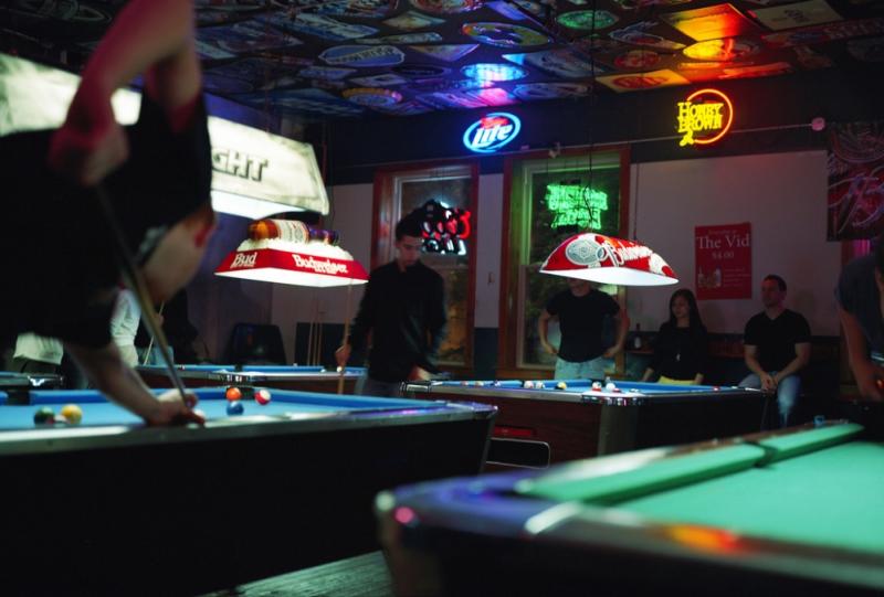 People playing pool on a pool table