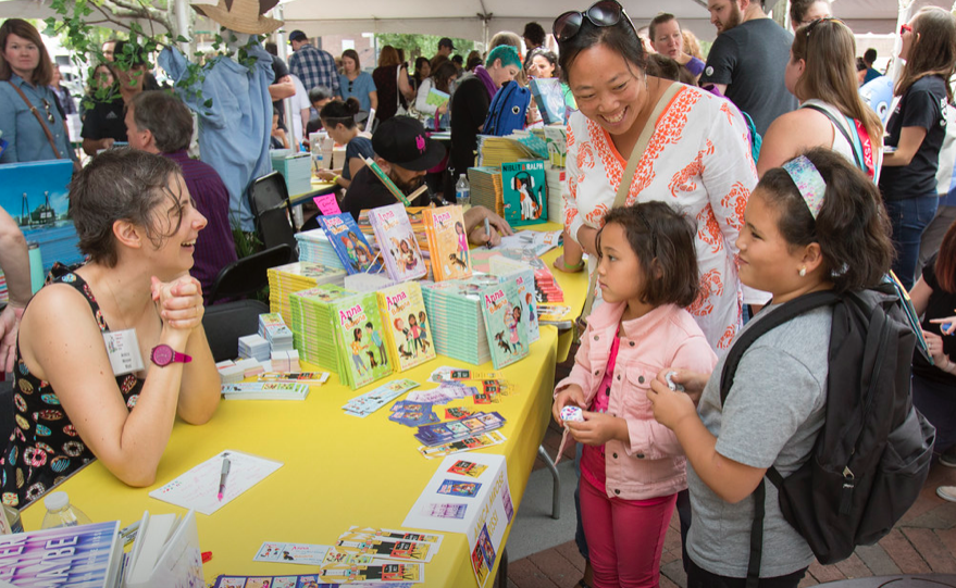 Author greeting a child at a book signing