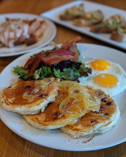 Pancakes with eggs and a green salad