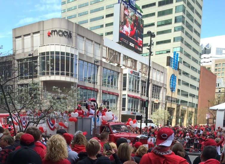 Cincinnati Reds fans watching Rosie Red on a parade float in downtown Cincinnati