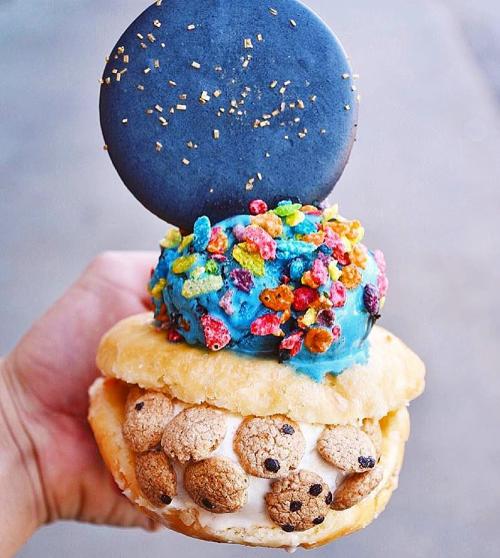 Doughnut ice cream sandwich with a scoop of ice cream and a macaron on top at Stacked Ice Cream.