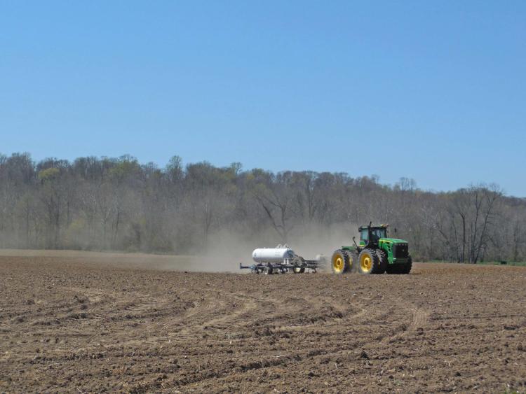 A tractor prepares the spring fields along Bain Road.