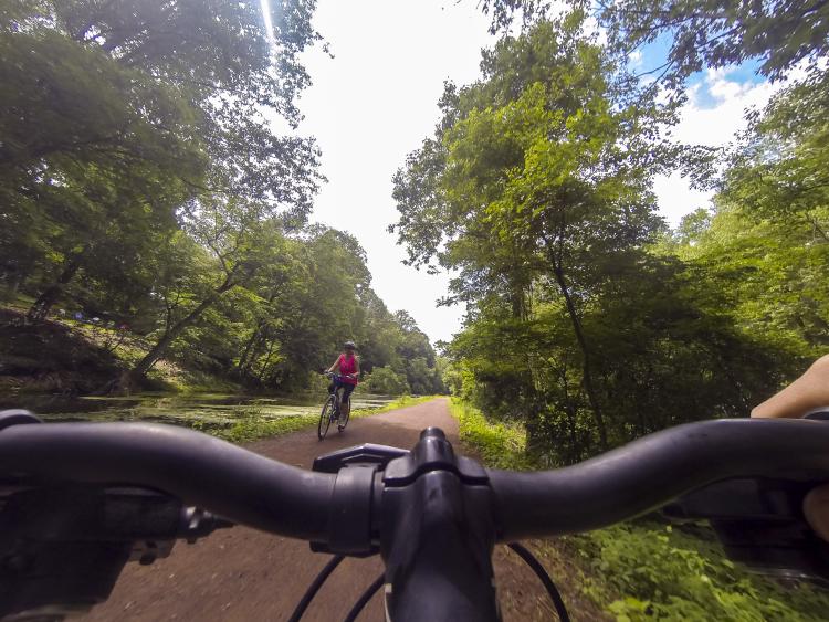 Biking the Delaware Canal woman passing Go Pro AS