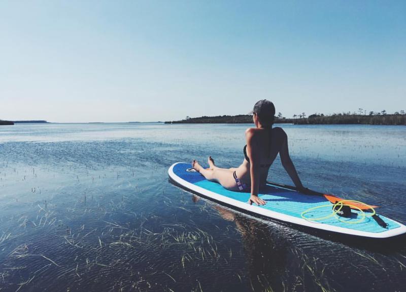 Woman Sitting On A Paddleboard At Back Bay National Wildlife Refuge