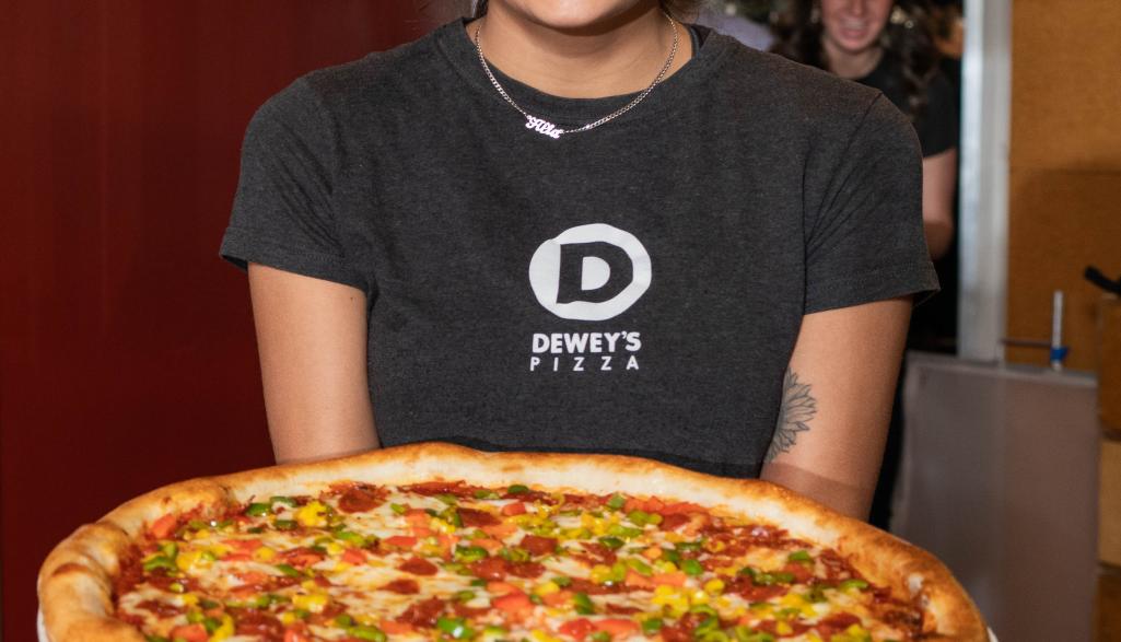 holding pizza