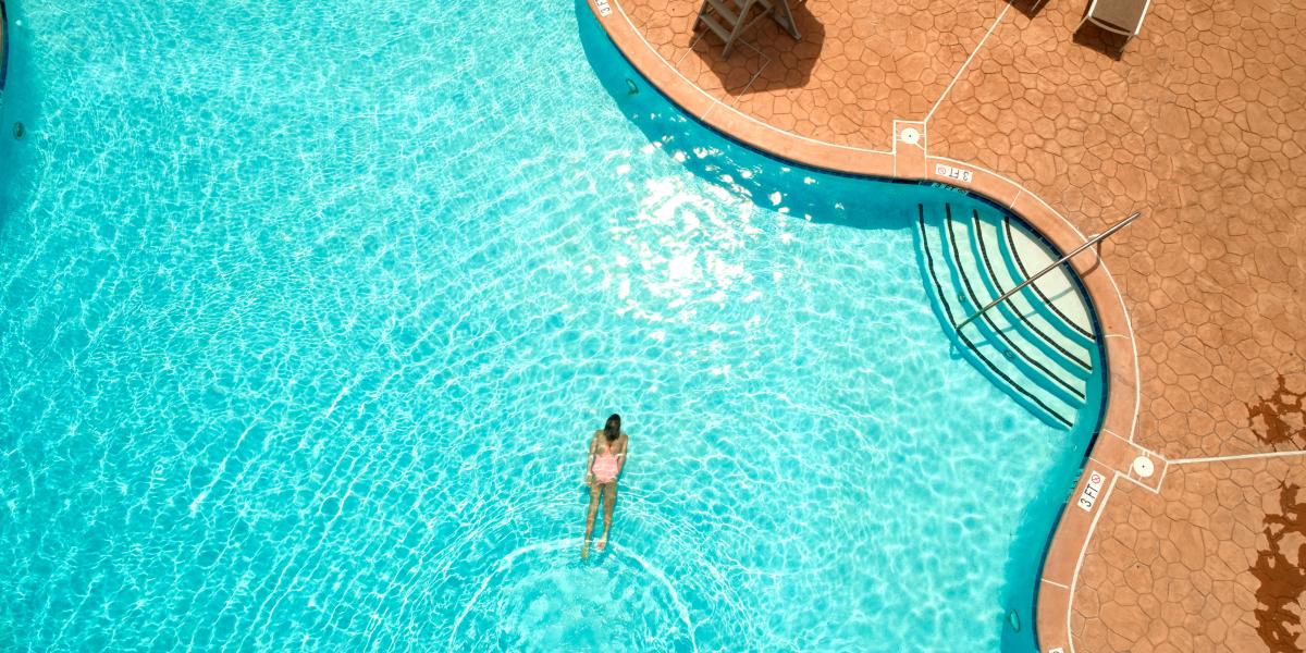Overhead view of one woman swimming in Lansdowne Resort pool