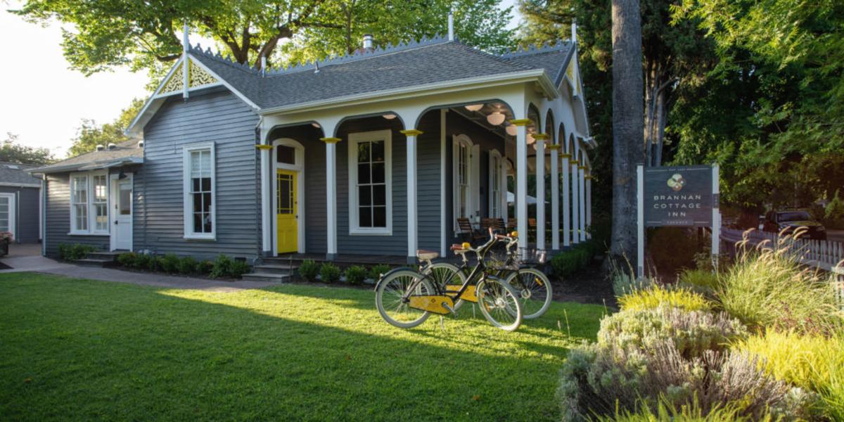 A well-manicured yard surrounds the exterior of Brannan Cottage Inn
