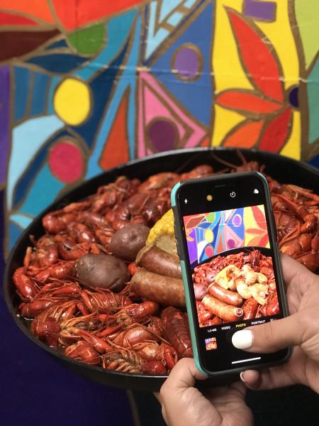 A visitor takes a picture of their crawfish meal in Beaumont, TX.