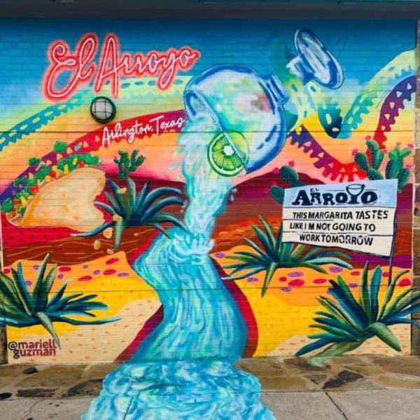 Photo of mural of dessert and margarita outside of El Arroyo