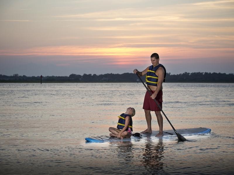 Father and son paddle boarding