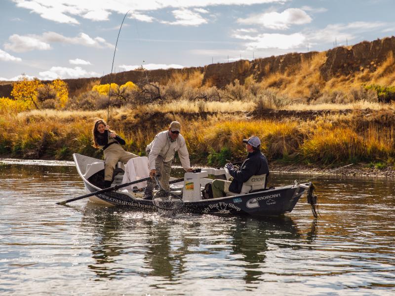 Friends On a Boat Fishing at North Platte Reeling in a Big Catch