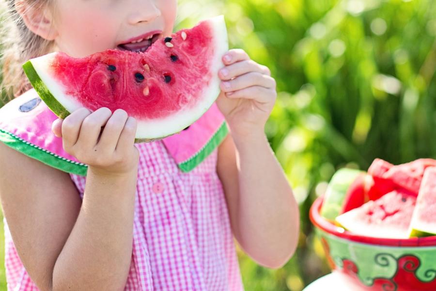 Little Girl Eating A Watermelon