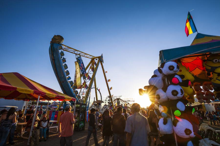 People walk the midway at the New Mexico State Fair
