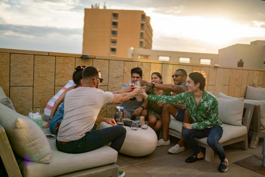 Friends with drinks at Level 5 Rooftop Bar