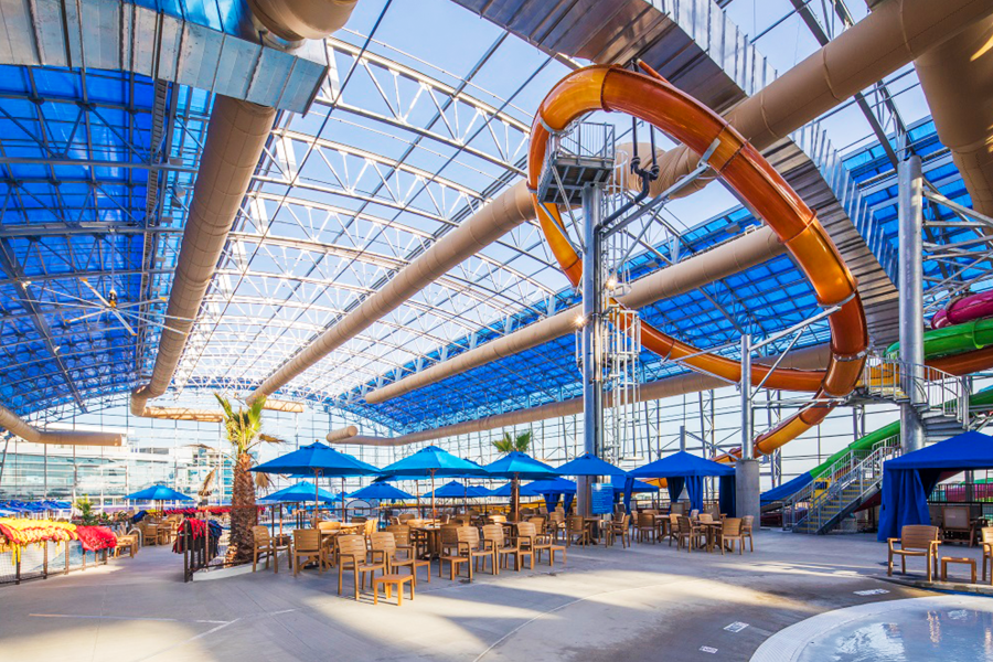 Photo of indoor water park with slide and tables