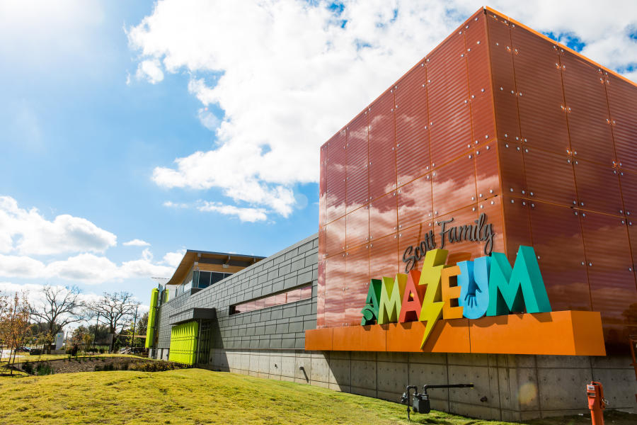 Image of the North East corner of the Scott Family Amazeum's exterior (the name of the museum is visibly shown)