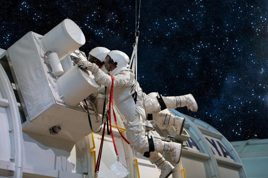 Astronauts Working On A Machine In Space