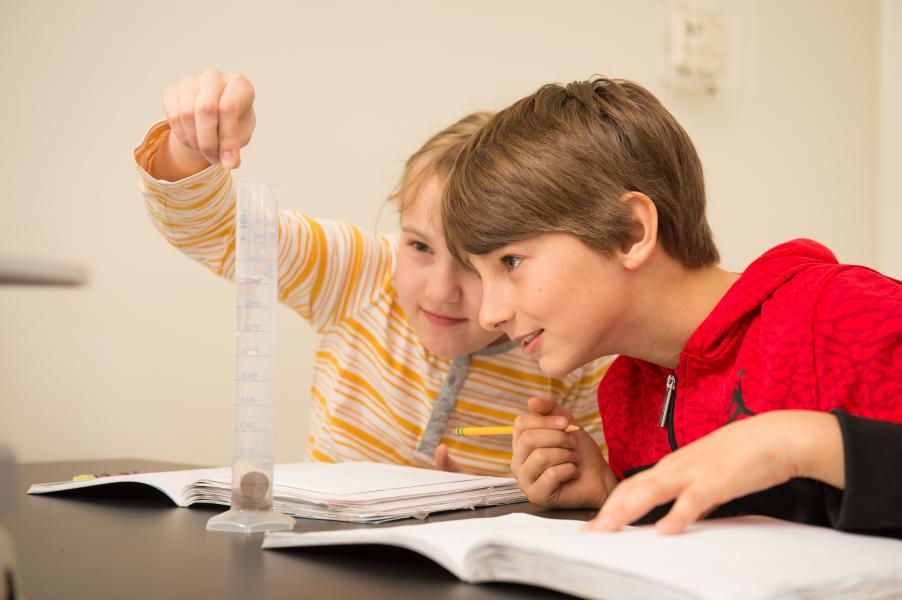 Children studying together with book