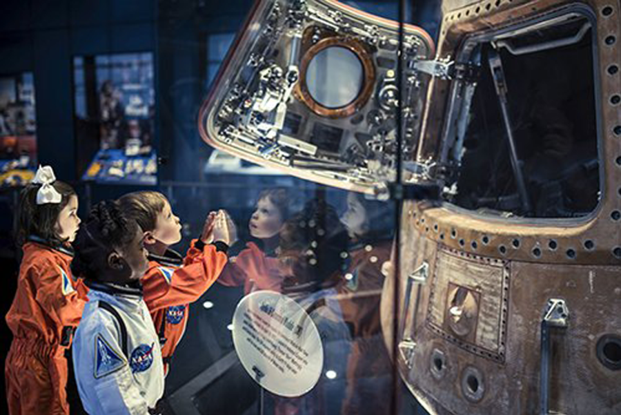 Children look on in awe at the Apollo 16 Command Module at the U.S. Space & Rocket Center.