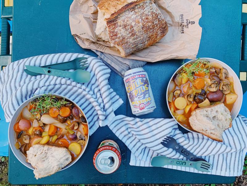 Bowls of one-pot vegetable stew and sourdough from Canadian Bakin, paired with Straight to Ale’s Juicy Bunny Pale Ale and Chill Pils Pilsner
