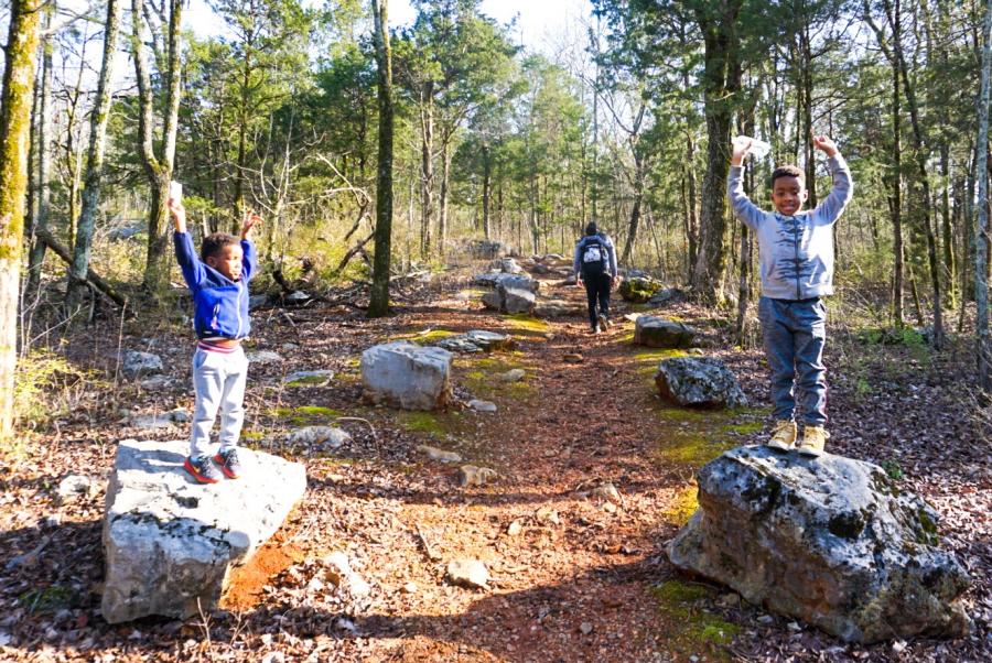 Kids Playing On Rocks In The Woods