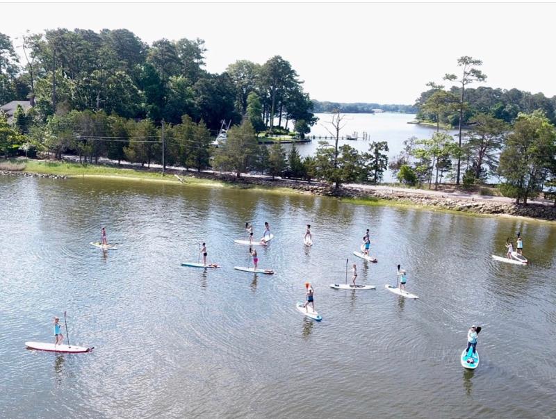 Group Of People Stand Up Paddleboarding First Landing State Park