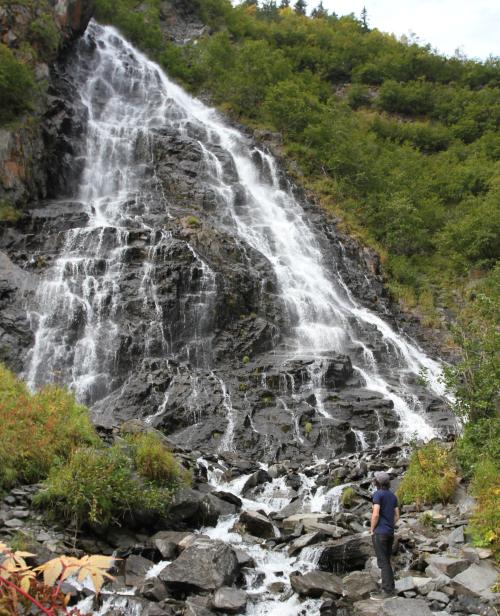 a person viewing a waterfall