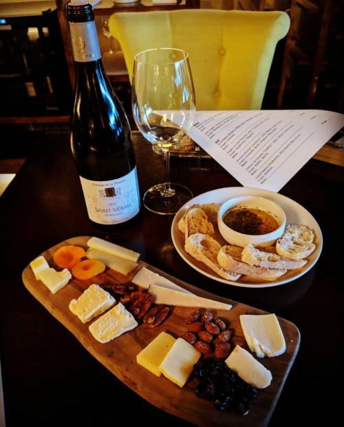 A glass of wine and a charcuterie board from Tinto Wine & Cheese in Virginia Beach
