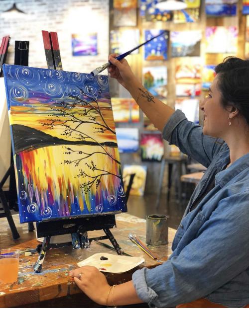 Woman Painting A Sunset At Muse Paint Bar In Virginia Beach