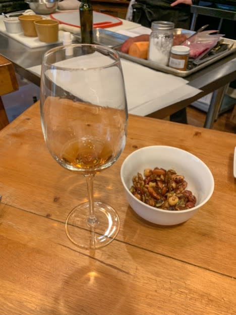 Glass of wine and bowl of nuts