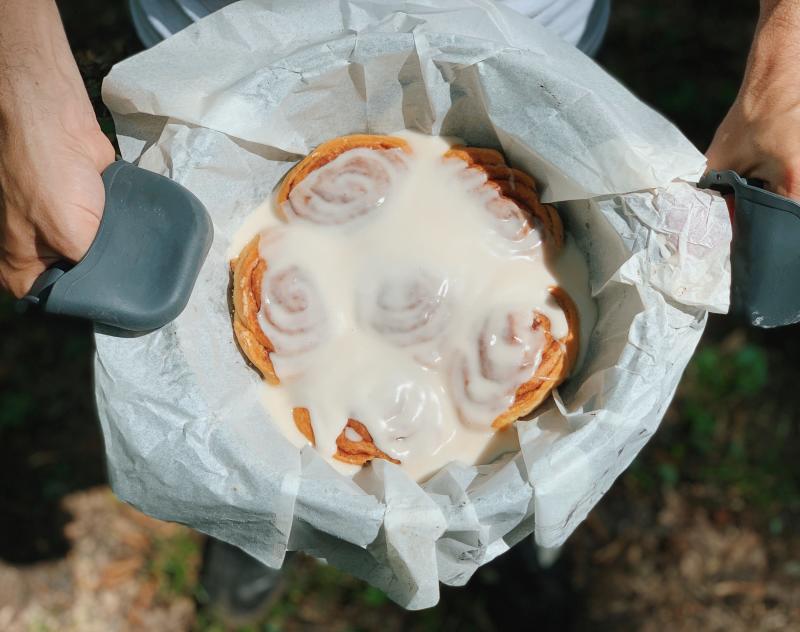 A baked pan of vegan CrumBites Delight's Cinnamon Rolls topped with icing in Huntsville, AL
