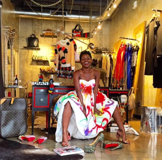 Woman in a colorful dress with shoes and other shopping merchandise