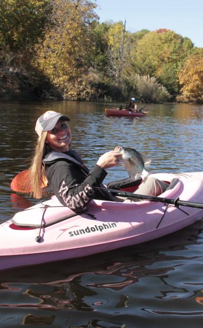 A woman who caught a fish kayaking